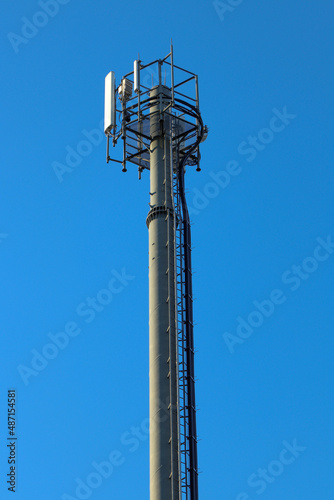 Telecommunication tower of 4G and 5G cellular. Macro Base Station. 5G radio network telecommunication equipment with radio modules and smart antennas mounted on a metal. Blue sky in the background.