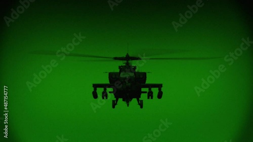 Apache AH-64 helicopter flies at night, night vision infrared photo