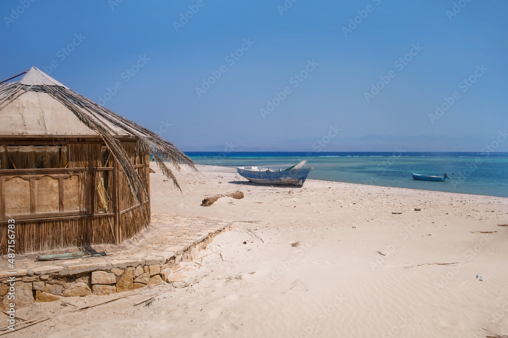old wooden fishing boats resting on the beach of the bay blue lagoon in egypt