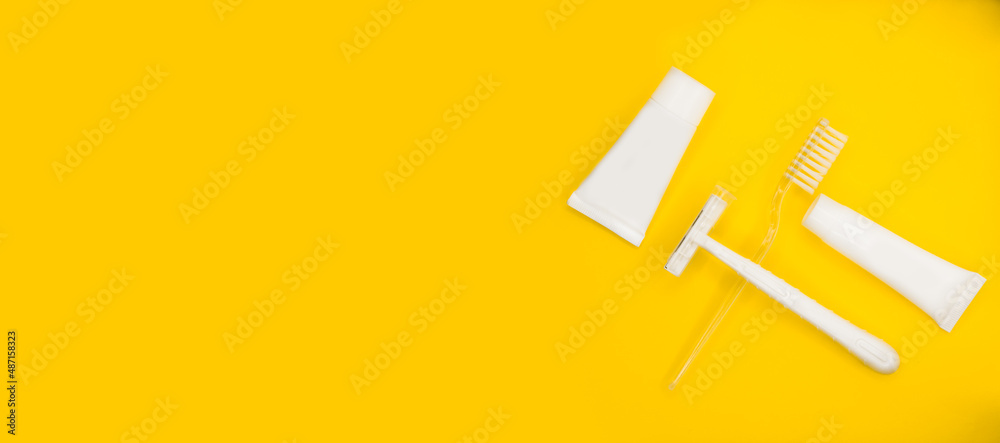 Toothbrush, razor, toothpaste, minimalistic yellow background. Toothbrush, razor, toothpaste, minimalistic yellow background.