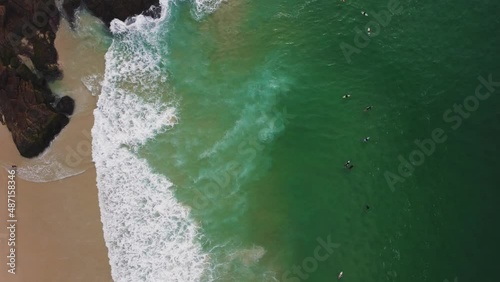 Aerial view of Praia da Joatinga, a paradise in Rio de Janeiro, Brazil. Sunny day with some clouds in the morning. Sea with good waves for surfers. Greenish sea. Drone take. photo