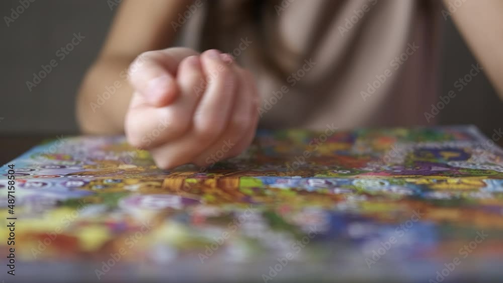 Playing alone board game. A girl playing alone with a dice with a board game. Playing alone board game. A girl playing alone with a dice with a board game.