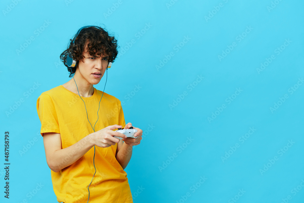 curly guy in headphones plays games gamepad Lifestyle entertainment
