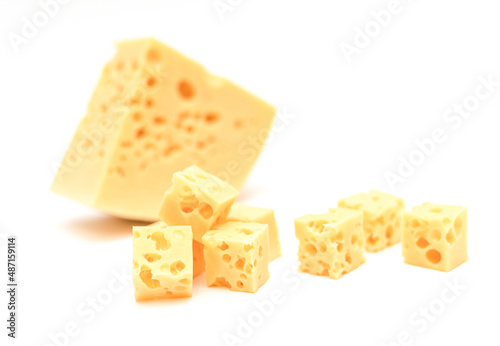 Appetizing square slices of cheese with holes on a white background