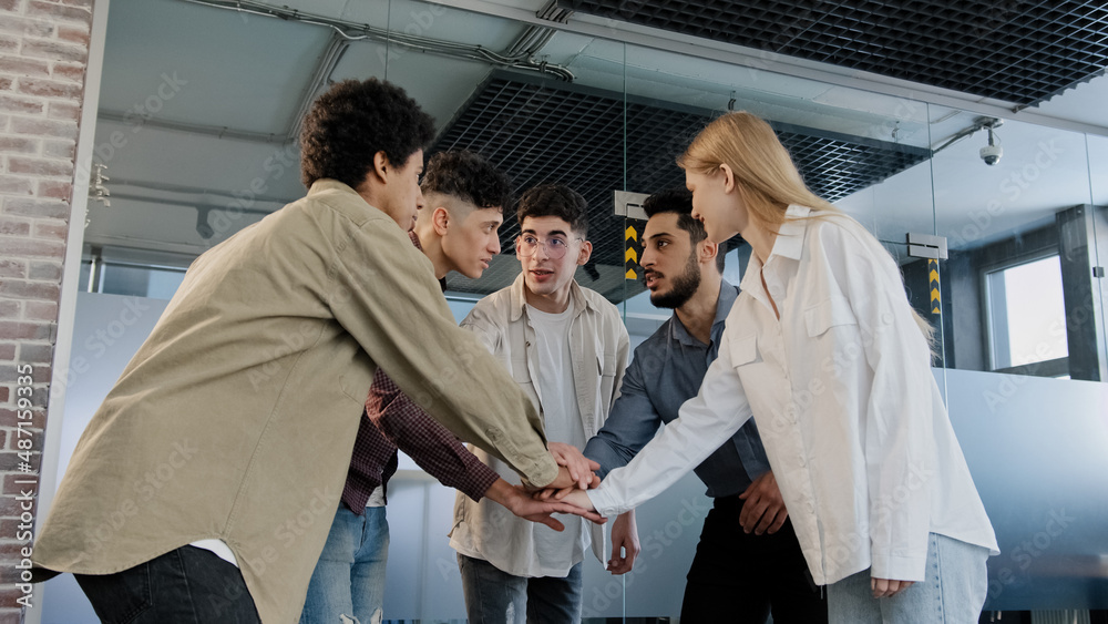 Naklejka premium Happy diverse group business people students stack hands together motivate for success participate in team building celebrate victory corporate partnership professional support trust in partnership