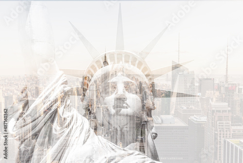 Double exposure of Manhattan skyline in new york city with statue of liberty silhouette