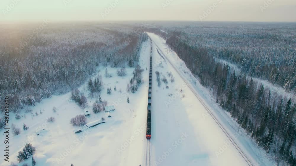 Shot on a drone. A freight train is traveling at high speed. A train for cargo transportation. Locomotive. Railway transport. Shot on a drone. A freight train is traveling at high speed. A train for cargo transportation. Locomotive. Railway transport.