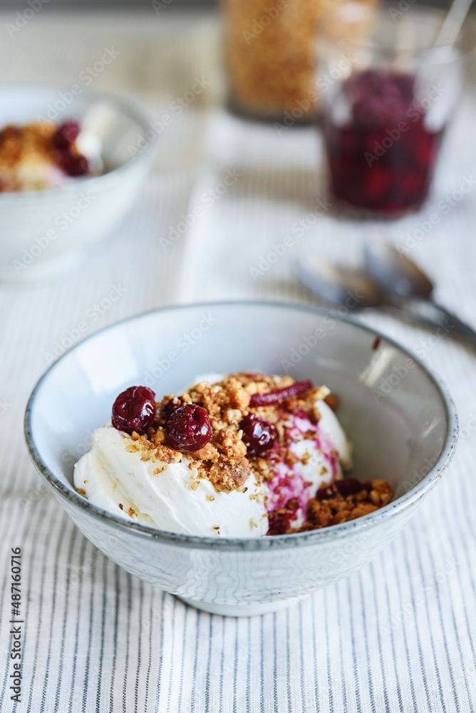 Cherry sauce, cream cheese and feta cream and crumble crust dessert. Homemade Sweet and salty cheesecake. Trifle. Selective focus Cherry sauce, cream cheese and feta cream and crumble crust dessert. Homemade Sweet and salty cheesecake. Trifle. Selective focus