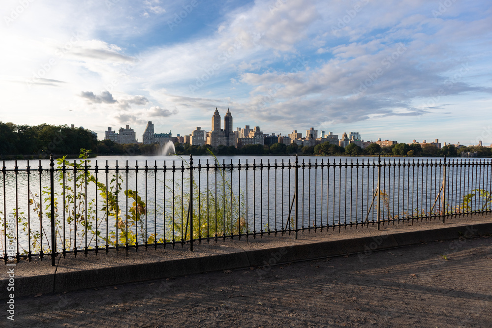 Trail along the Central Park Reservoir with a View of the Upper West Side Skyline in New York City