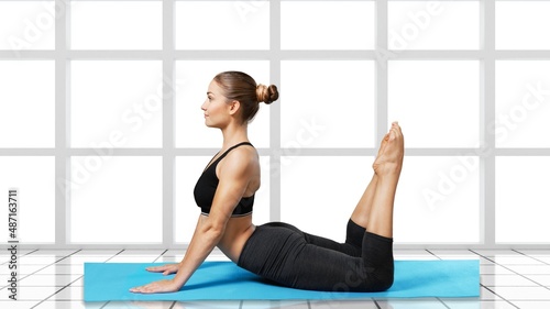 Happy woman wearing sportswear doing Yoga exercise, meditation with yoga at home