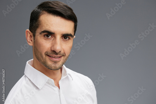 handsome man in a white shirt a pensive look isolated background