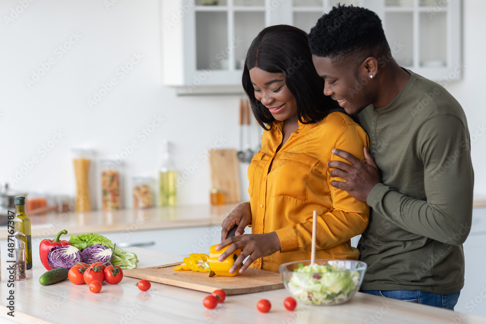 Portrait Of Happy Black Lovers Preparing Healthy Food Together In Kitchen