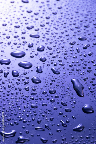 Abstract blue water drops on dark  surface