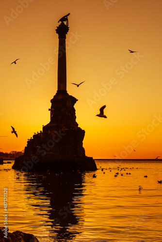 Sunset on embankment of Sevastopol. Monument to sunken ships against the sun. Sevastopol  Crimea