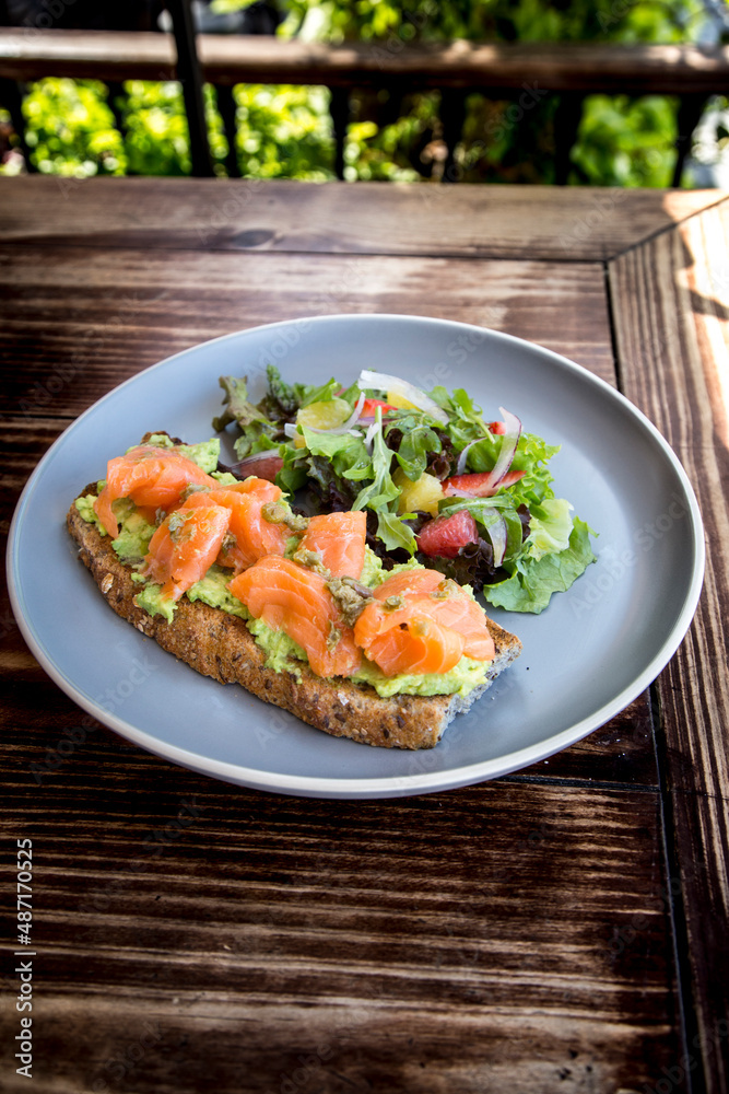 Delicious and light breakfast with Salmon on a bed of guacamole, bread and our delicious house salad.