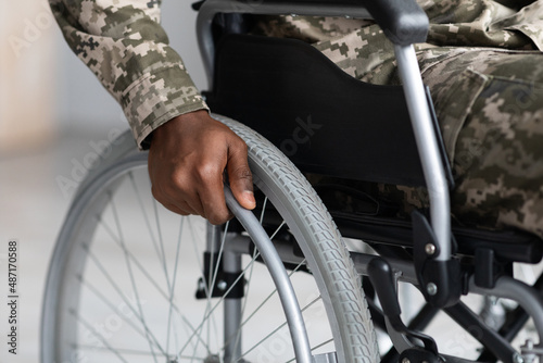 Unrecognizable african american soldier sitting in wheelchair