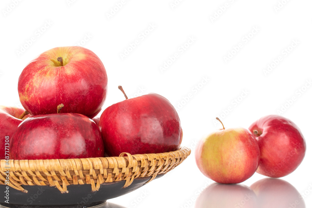 Several ripe red apples with a ceramic dish, macro, isolated on a white background. Several ripe red apples with a ceramic dish, macro, isolated on a white background.