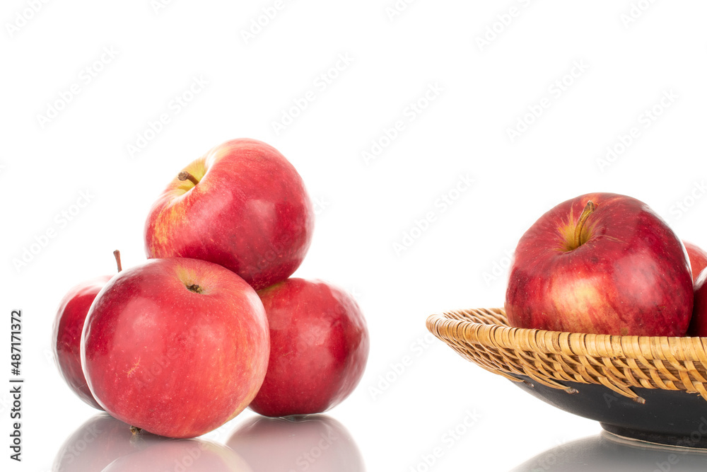 Several ripe red apples with a ceramic dish, macro, isolated on a white background.