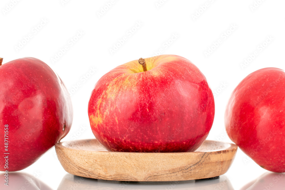Three ripe red apples with wood saucer, macro, isolated on white background. Three ripe red apples with wood saucer, macro, isolated on white background.