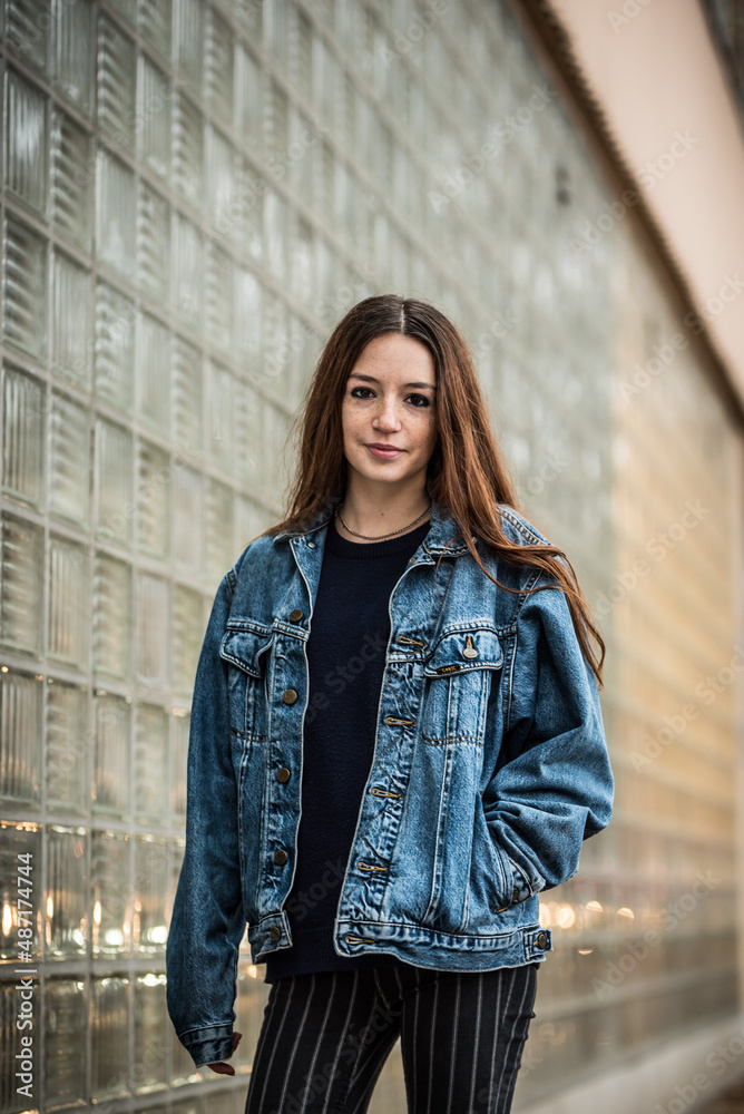 Fashion portrait of an 18 year old red haired pritty girl standing against a wall Fashion portrait of an 18 year old red haired pritty girl standing against a wall
