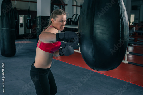 Woman boxing with punching bag © andyborodaty