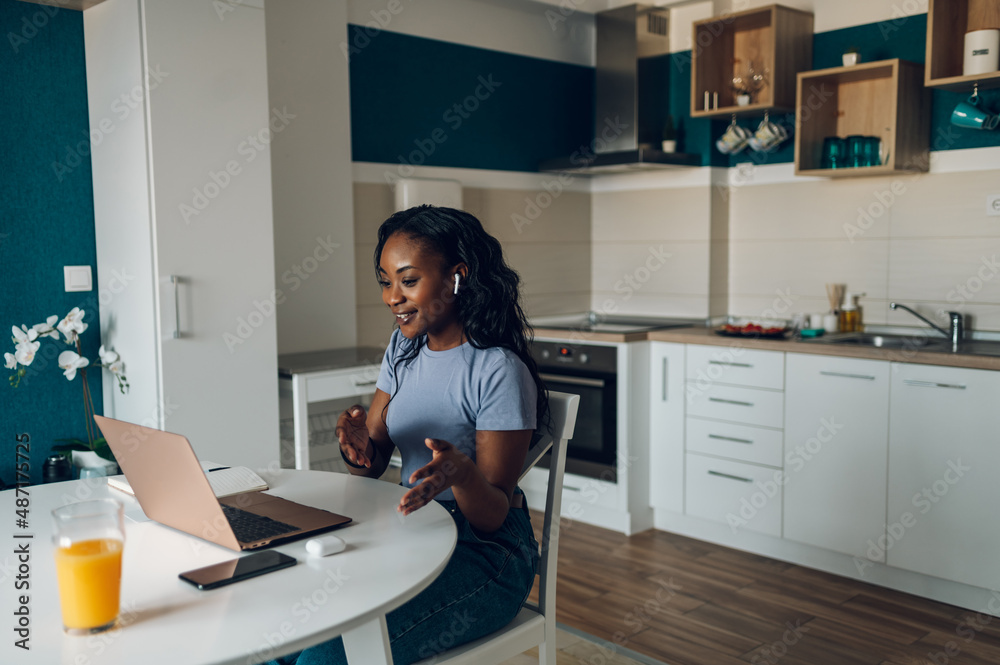 Young african american woman working from home and using a laptop Young african american woman working from home and using a laptop