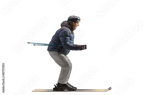 Full length profile shot of a mature man on skiis