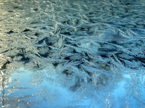 Frost across smooth glass with winter morning light