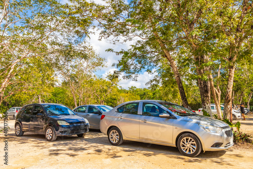 Parking lot with cars jungle to Kaan Luum lagoon Mexico.
