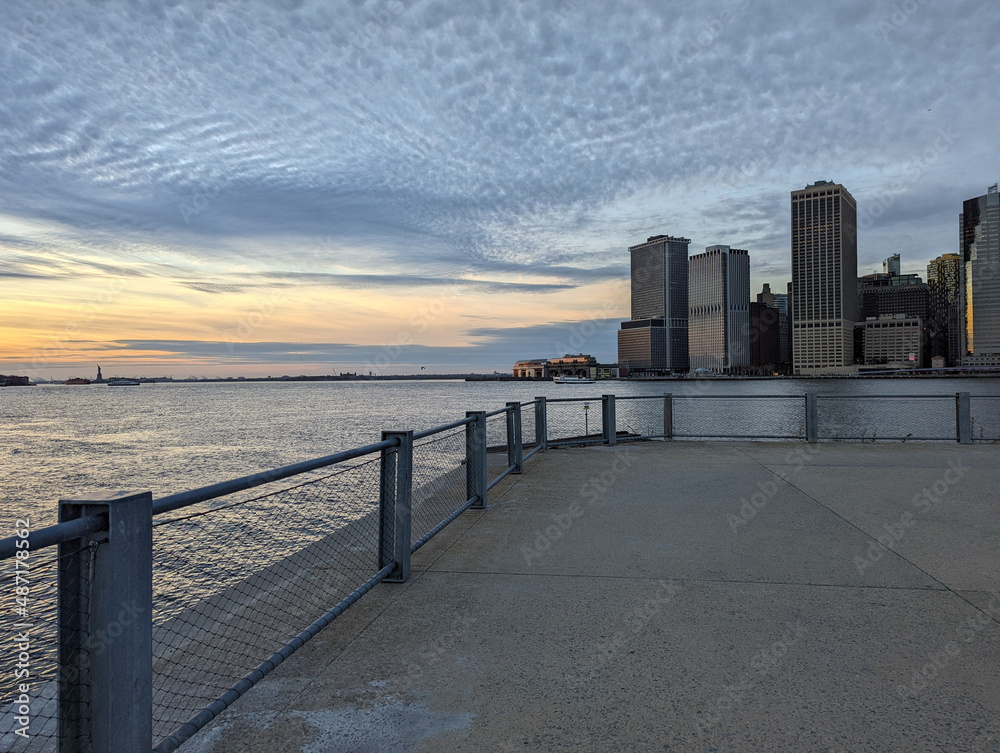 Skyline of financial district in New York City with modern office buildings seen from pier Skyline of financial district in New York City with modern office buildings seen from pier