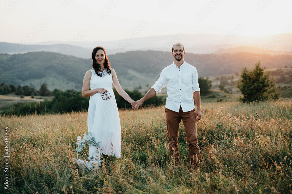Happy Married holding hands in the park at sunset Happy Married holding hands in the park at sunset