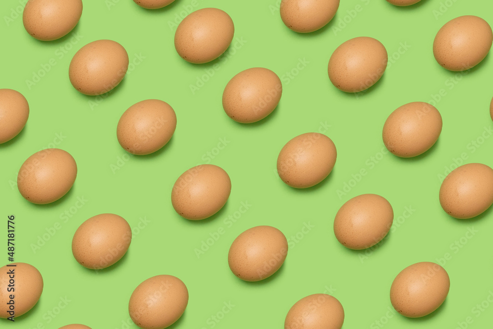 Collection of random color pattern eggs on green background. Happy Easter.