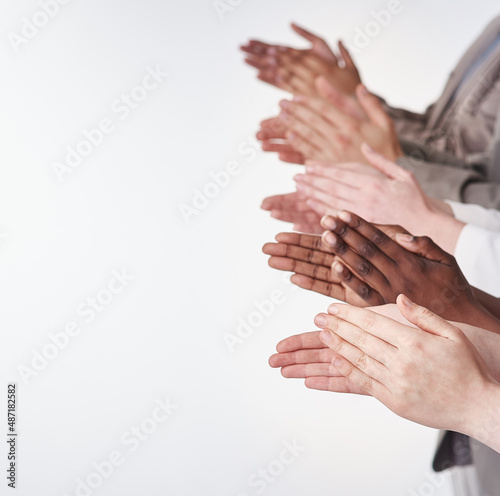 Rounds of applause. Shot of a group of people clapping their hands together. photo