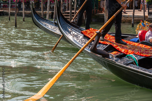 Gondoliers standing on top of gondolas rowing, Venice, Italy