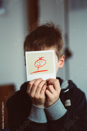 Young boy with instant photo Polaroid photo