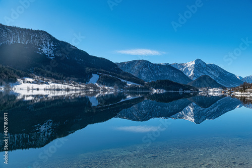 Breathtaking view over Grundlsee in Salzkammergut  Ausseerland  snowcaped Mountains reflecting in crystal clear mountain lake  Winter Wonderland in Austria