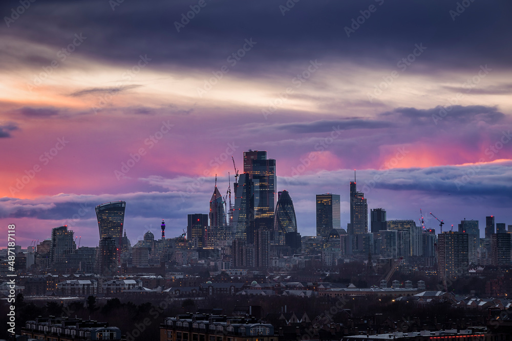 Skyline of the City of London, England, with colorful clouds during a rainy sunset