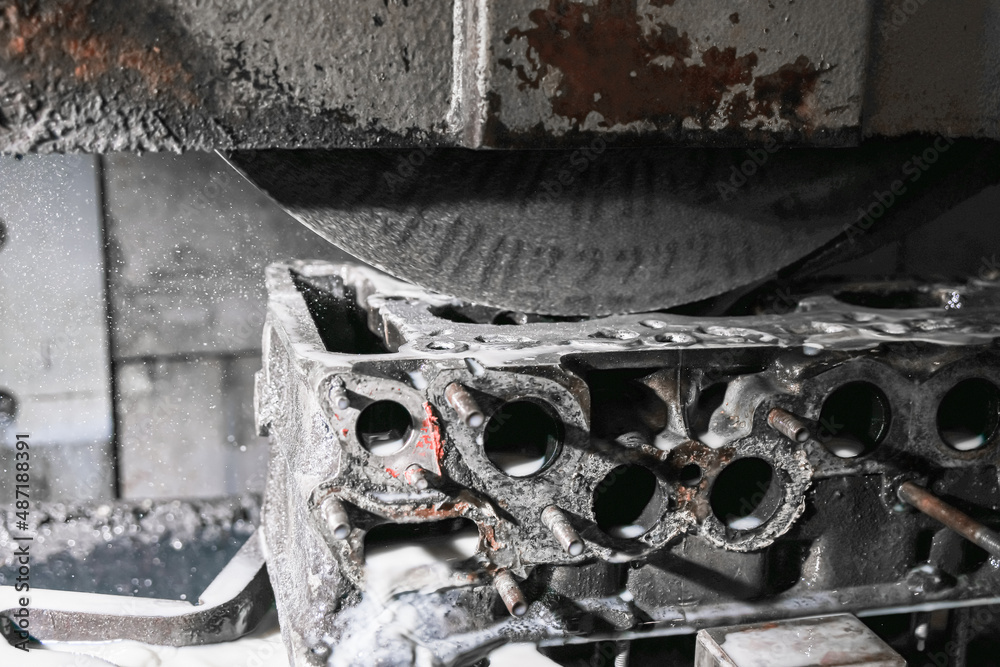 Grinding the surface of the cylinder head on a surface grinder. Grinding the surface of the cylinder head on a surface grinder.