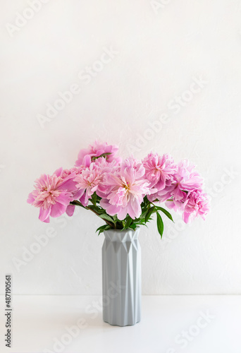 Still life with a beautiful bouquet of pink peony flowers. Vertical crop. Copy space.