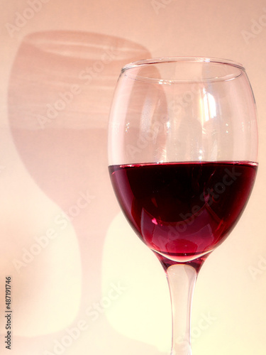 Glass of red wine with shadow
