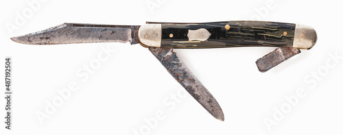 Highly detailed very old folding knife on white background.