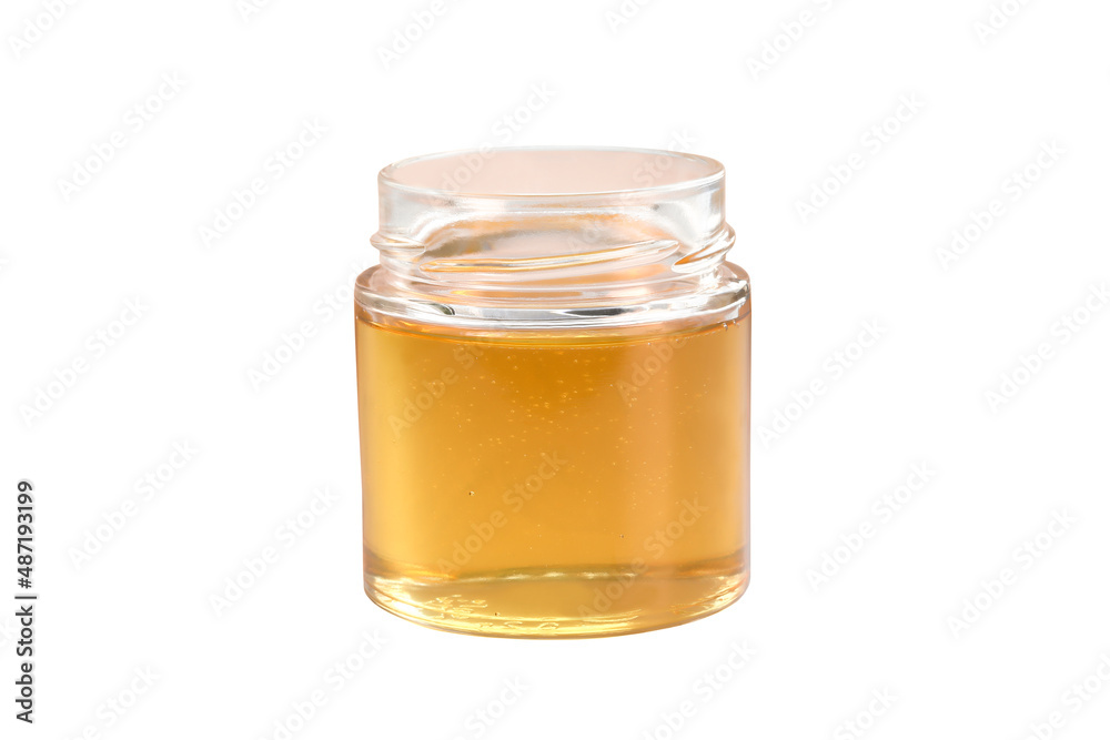 honey from a glass jar stands isolated on a white background honey from a glass jar stands isolated on a white background