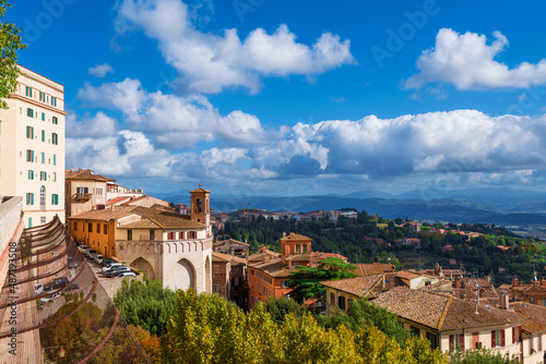 View of Perugia medieval historic center with ancient Sant'Ercolano church and Umbria countryside from city panoramic terrace