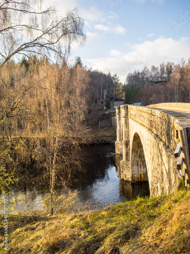 Scottish landscape with road and old stone bridge