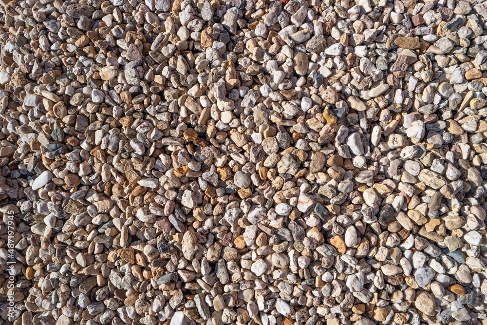 Round river pebbles as a background and texture, closeup, details. Round river pebbles as a background and texture, closeup, details.