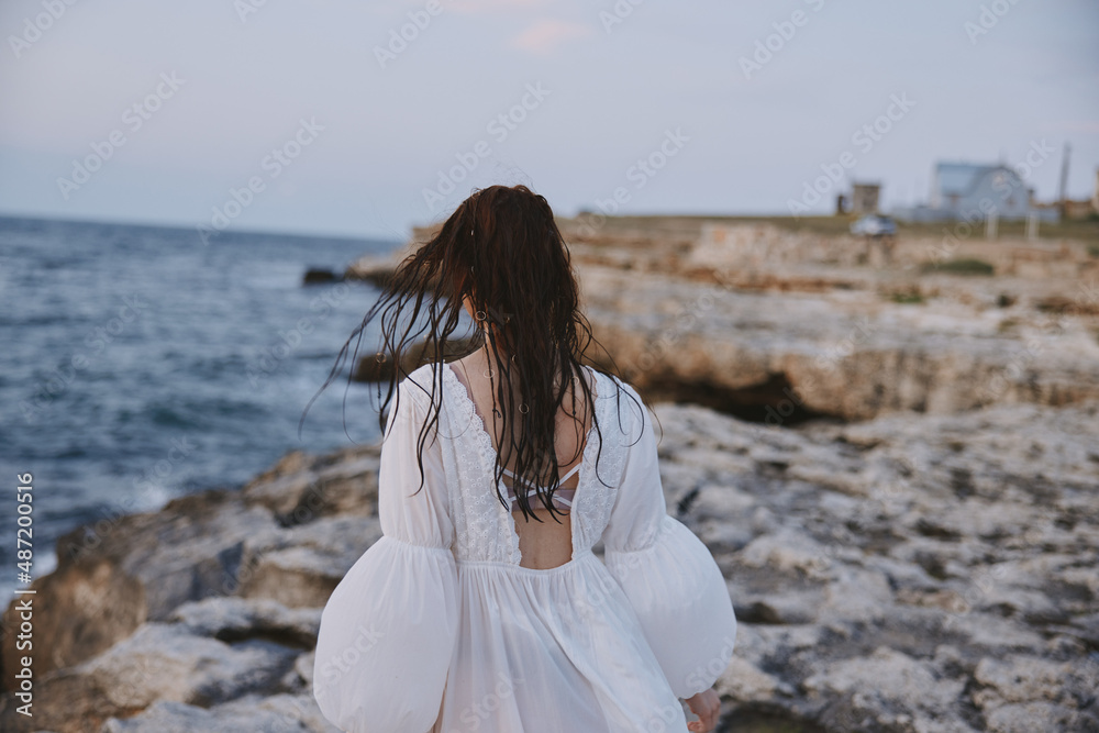 Woman in white dress summer walk ocean landscape travel Woman in white dress summer walk ocean landscape travel