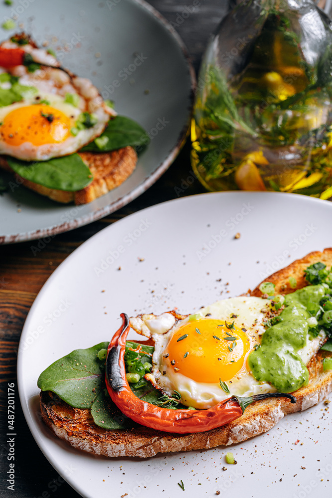 delicious and appetizing bruschetta with fried eggs and herbs for breakfast delicious and appetizing bruschetta with fried eggs and herbs for breakfast