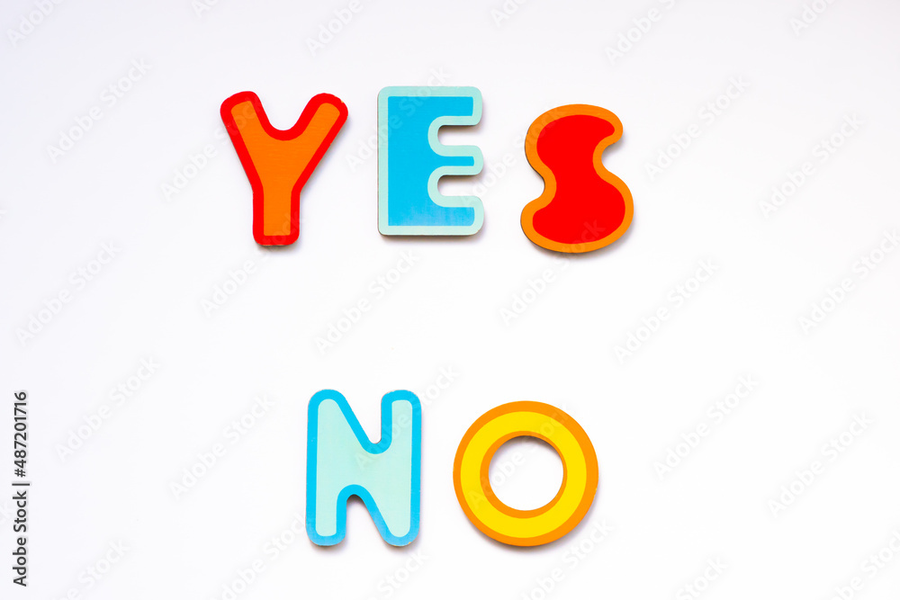 Yes and No words made of colorful wooden toy letters on white background. Choice yes or no concept.