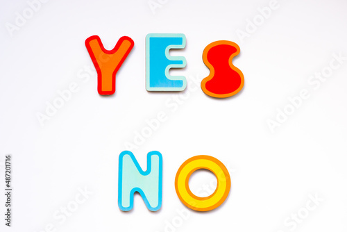 Obraz na płótnie Yes and No words made of colorful wooden toy letters on white background. Choice yes or no concept. w salonie