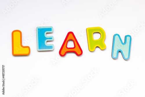 Obraz na płótnie Learn word made of colorful wooden toy letters. School alphabet on white background. w salonie